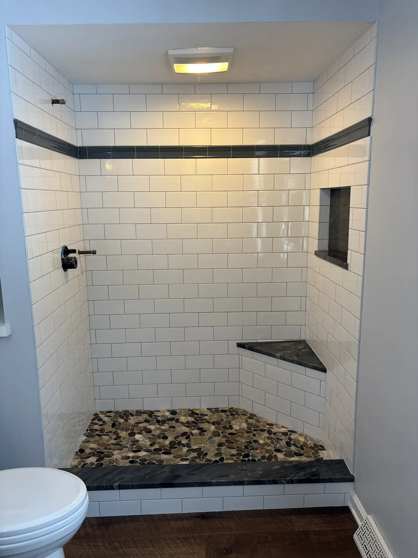 Overhead shower view with ceramic subway tile